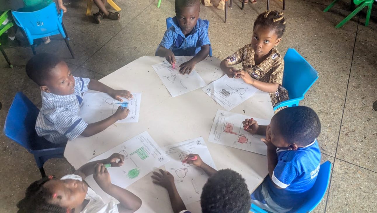Young pupils completing classroom learning activities